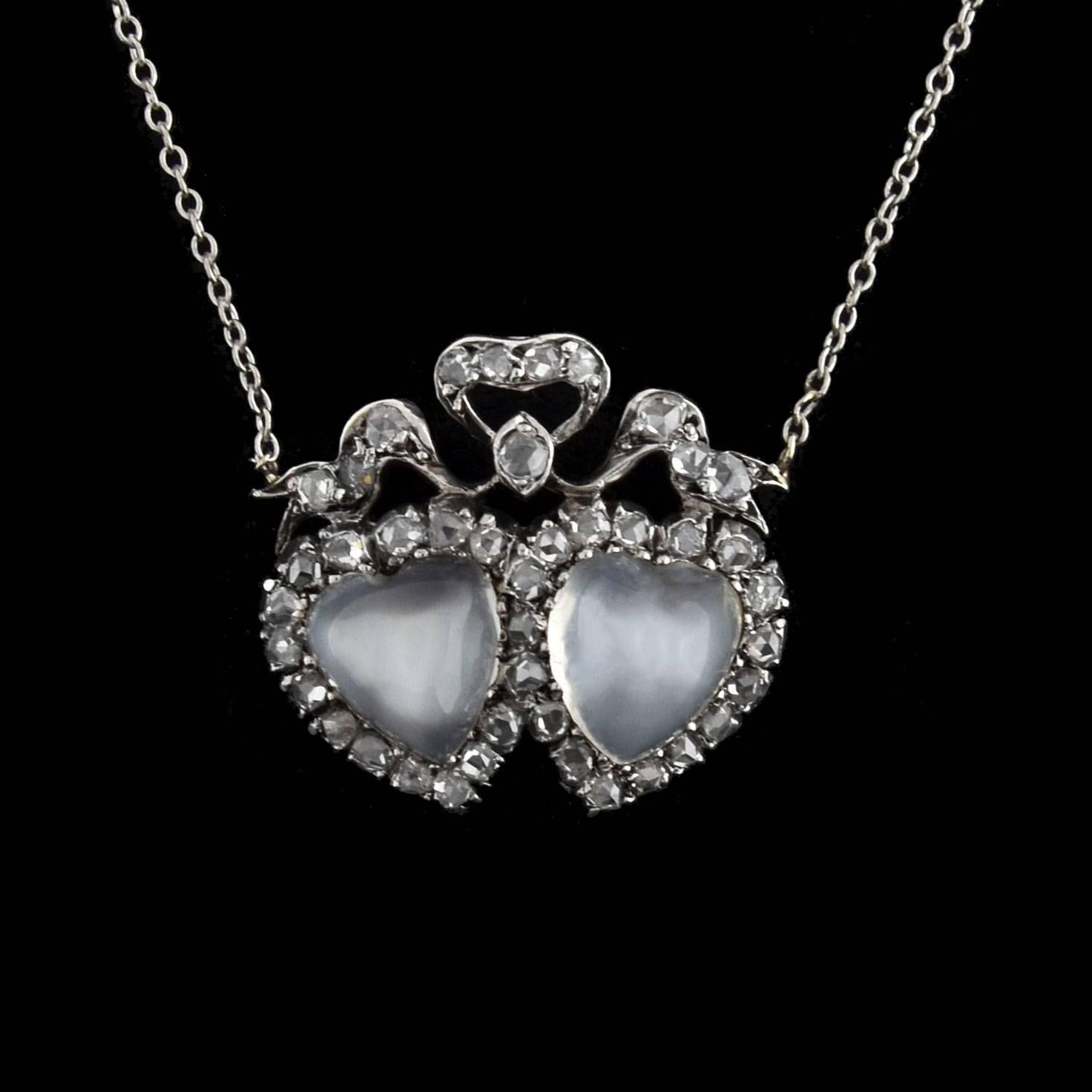 An incredible moonstone and diamond necklace from the late Victorian (ca1900) era! This gorgeous piece is made of silver-topped 14kt yellow gold and has a romantic double heart design. Two heart-shaped moonstone cabochons are nestled together at the