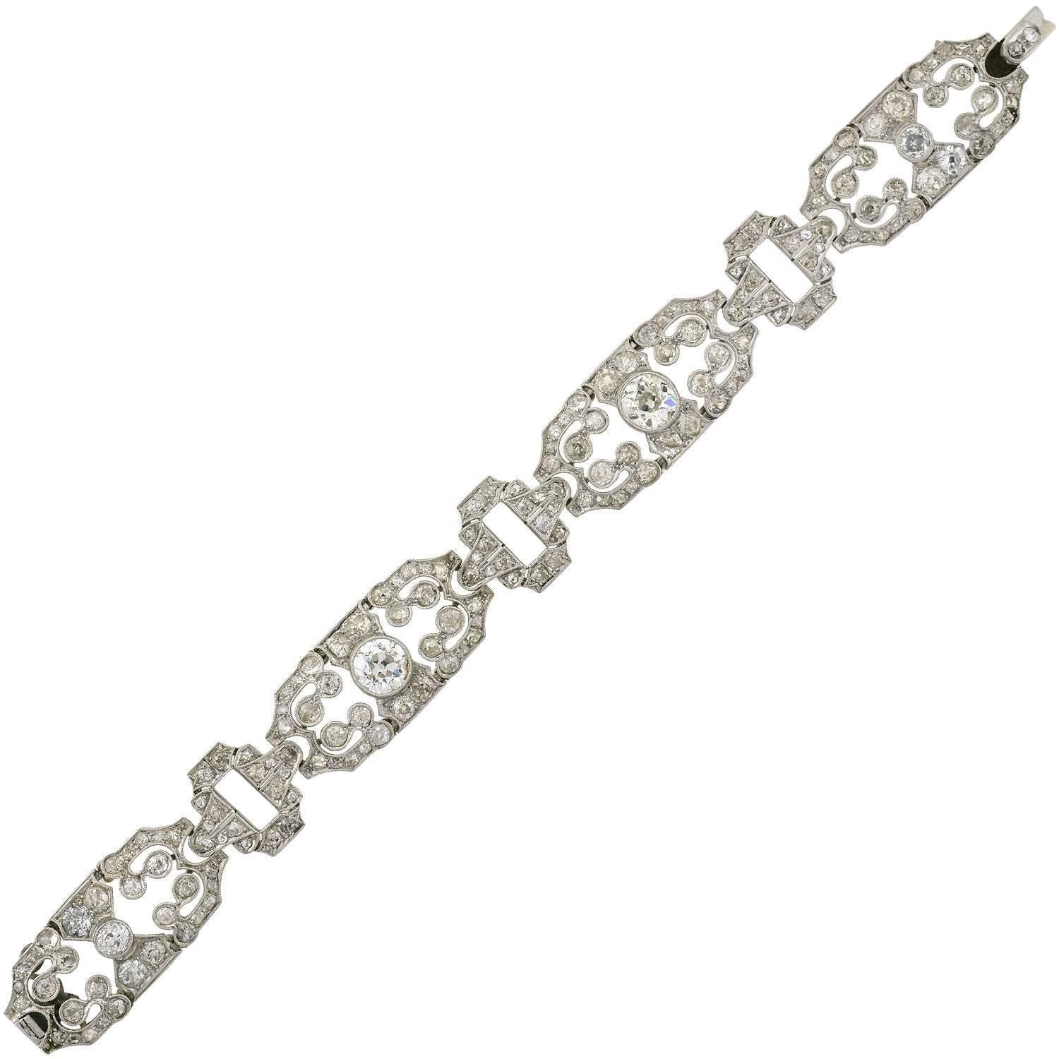 An absolutely exquisite diamond encrusted bracelet from the Art Deco (ca1920) era! This gorgeous handmade piece is made of platinum and features 4 diamond encrusted links that alternate with more subtle, smaller diamond links. In total, the bracelet