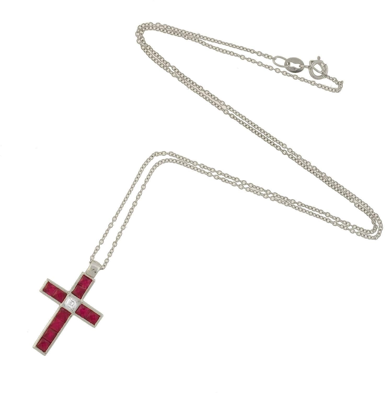 A beautiful Vintage cross necklace from the 1950s! The lovely piece is made of 18kt white gold and forms the shape of a cross. The front surface of the cross is represented by 10 calibrated French Cut rubies, totaling approximately 1.50ctw, and one