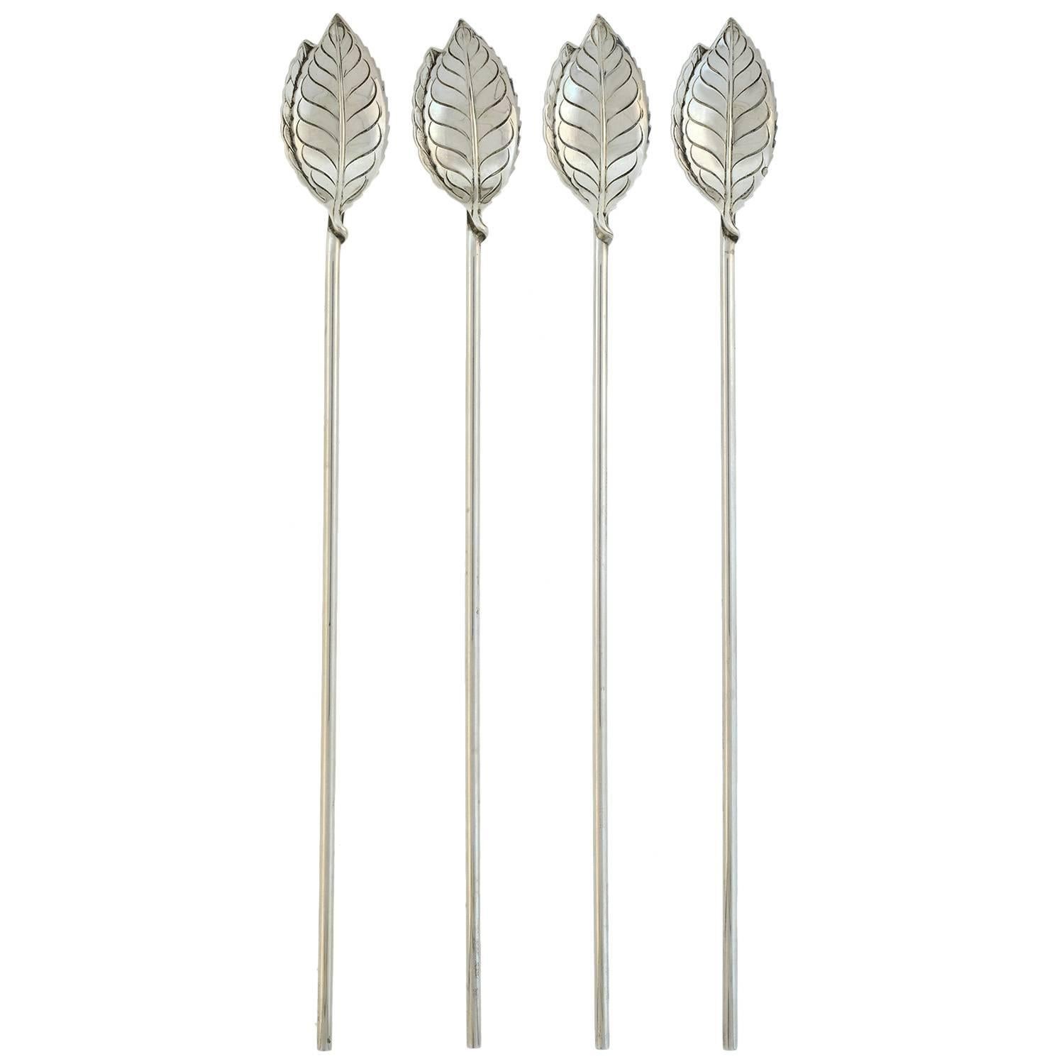 A stunning Vintage spoon set from the 1950s! Made by legendary maker Tiffany & Company, this fabulous set consists of 4 iced tea sipping spoons which have a leaf design and sterling bodies. The spoons are very long in length and the handle of each