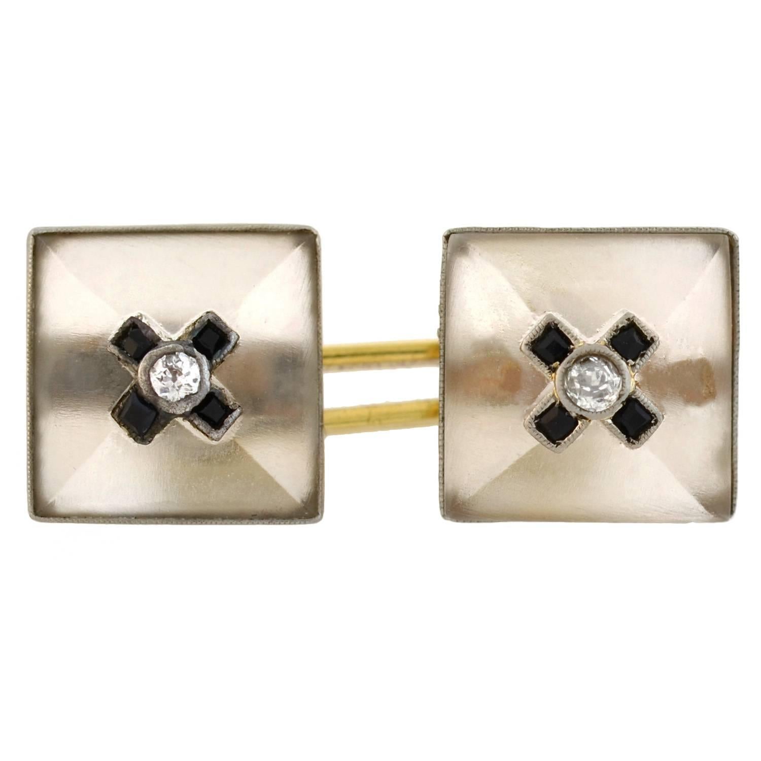Fabulous double-sided cufflinks from the Art Deco (ca1920) era! Each cufflink is crafted in platinum topped 14kt yellow gold and has two frosted rock quartz crystal faces which are square in shape. The rock crystal plaques have a 3-dimensional