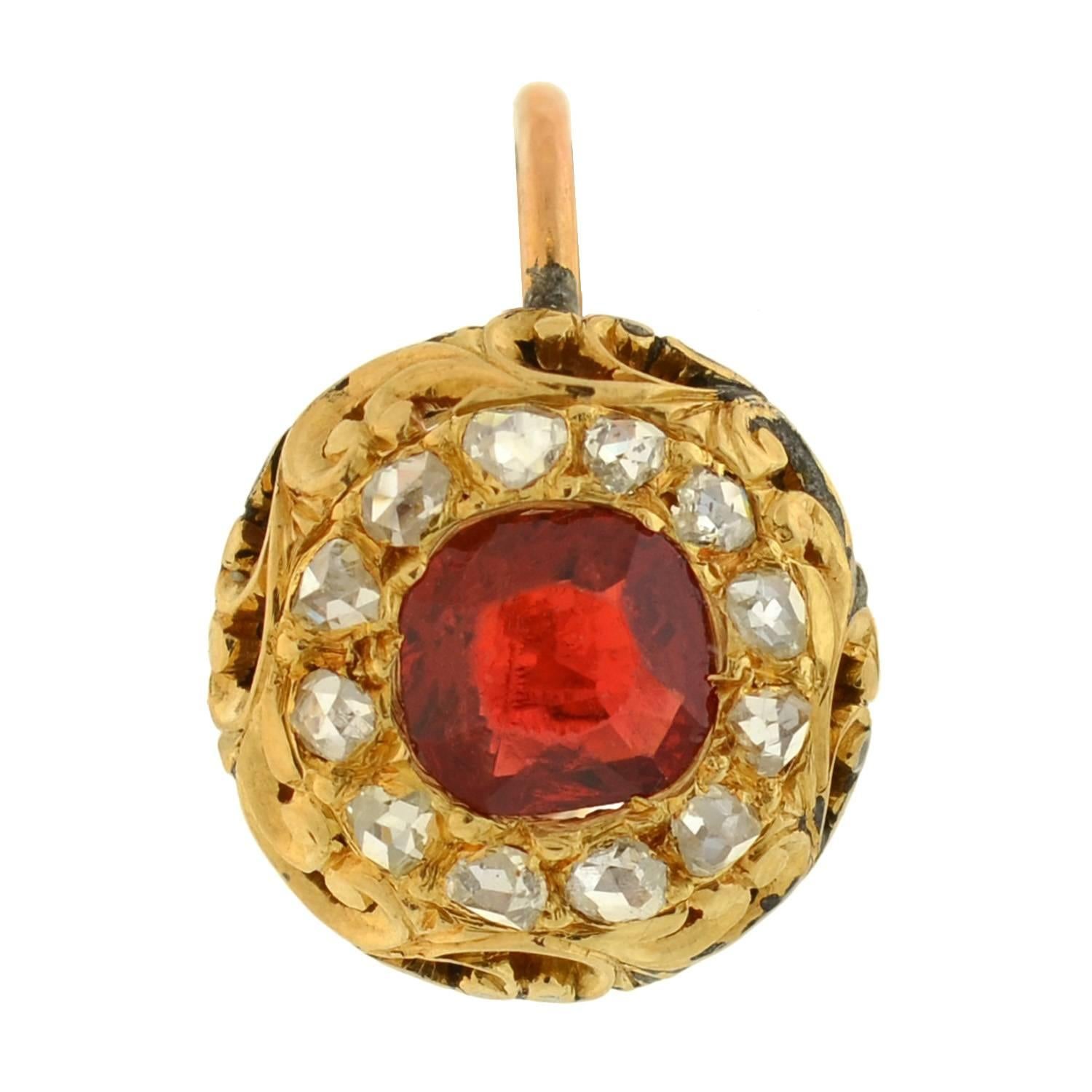 A gorgeous pair of spinel and diamond earrings from the Victorian era (1880)! Each 14kt gold earring frames a luscious red spinel at the center of a rose cut diamond halo. One of the spinels is a Cushion Cut stone, while the other is a Modified