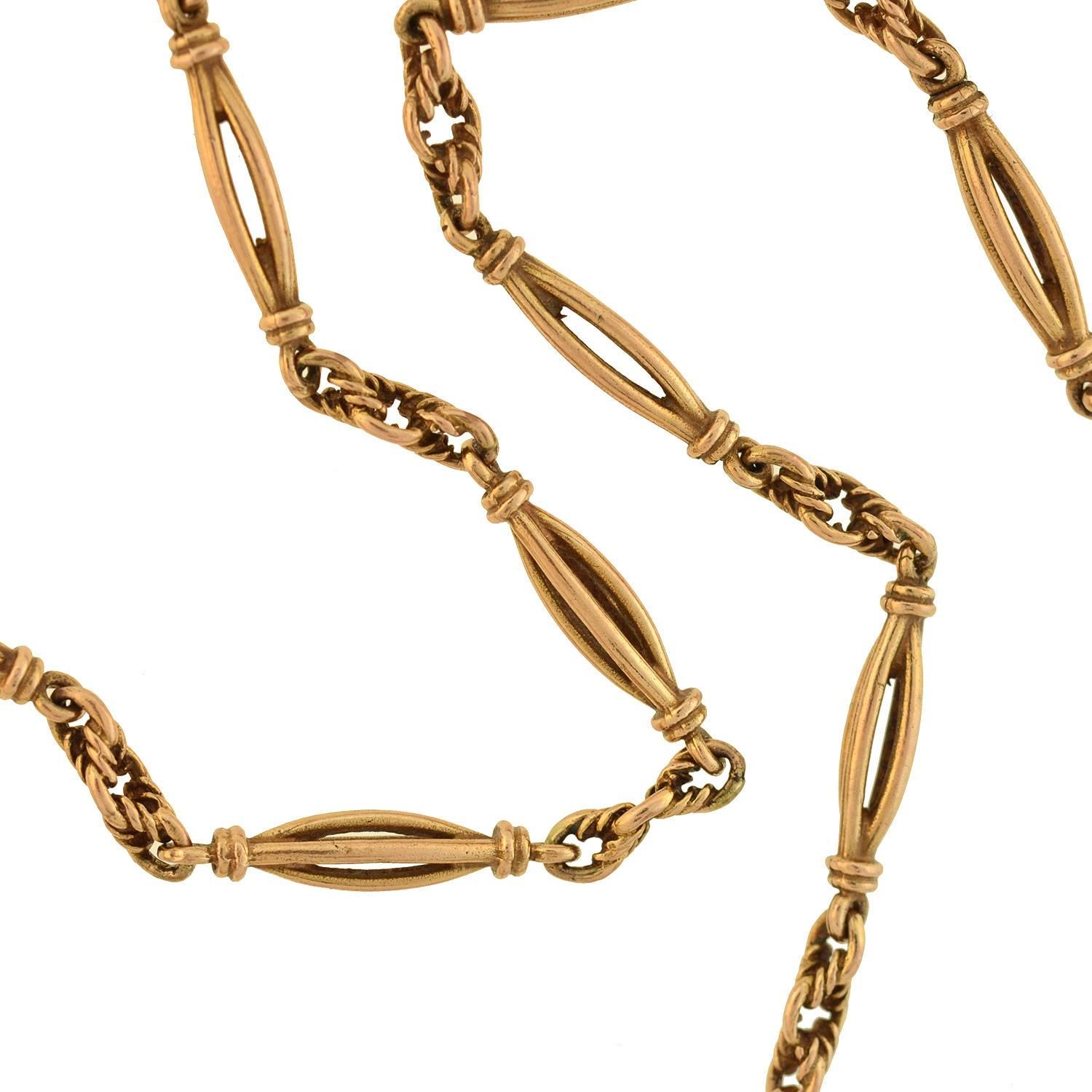 A gorgeous gold watch chain from the Victorian (ca1880) era! Crafted in 9kt rose gold, this fancy chain is comprised of bold ellipse-shaped open wirework links, which alternate with textured connector rings to form a medium length, flowing necklace.