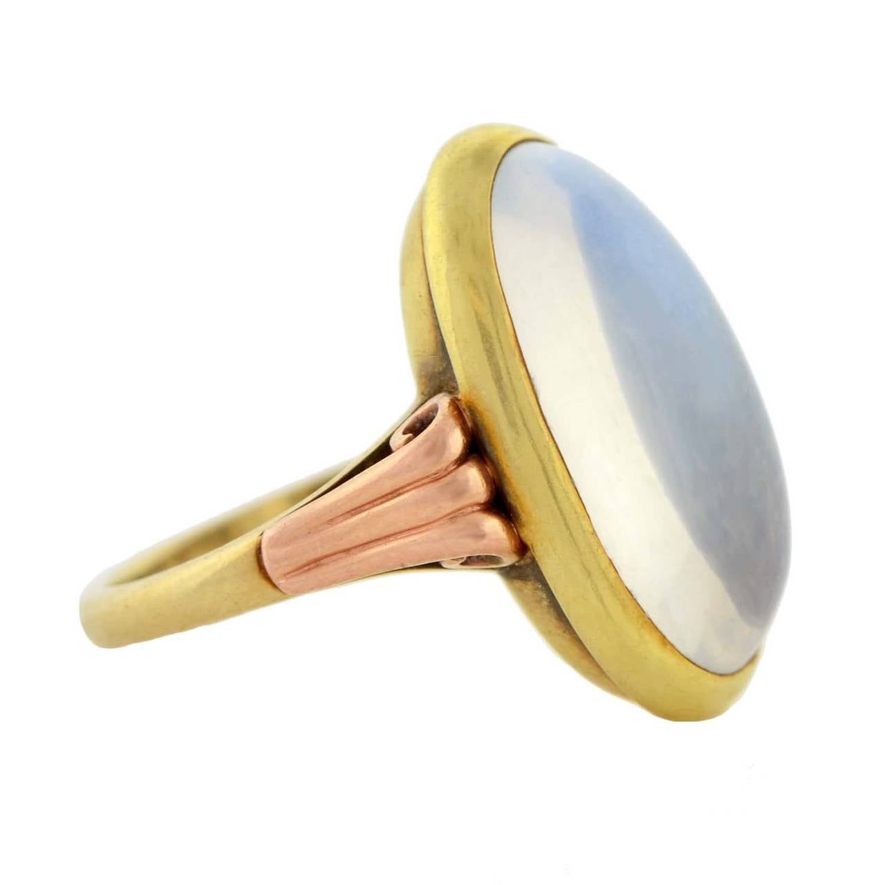 A beautiful moonstone ring from the Art Nouveau (ca1900) era! This lovely piece is made of 14kt yellow and rose gold and has an oval cabochon moonstone set in the center. The moonstone displays an alluring translucent quality with soft flashes of