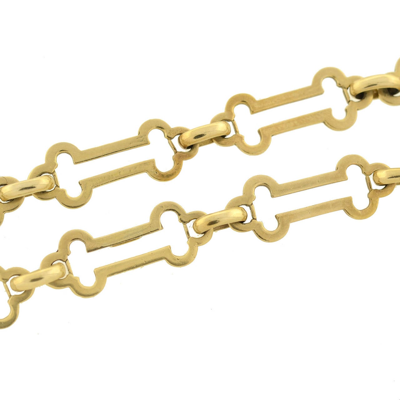 A fabulous Tiffany & Co. open link chain from the 1980's! This wonderful piece is made of 14kt yellow gold and comprised of large flat barbell shaped links that alternate with simple gold rings. The uniquely shaped links have cutout centers and the