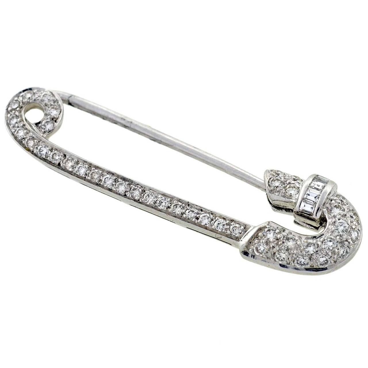 A fabulous Vintage gold and diamond pin from the 1950's! This attractive piece is made of 18kt white gold and portrays the shape of a large and functional safety pin. The head, side and hinge are accented with sparkling pave set diamonds, which add