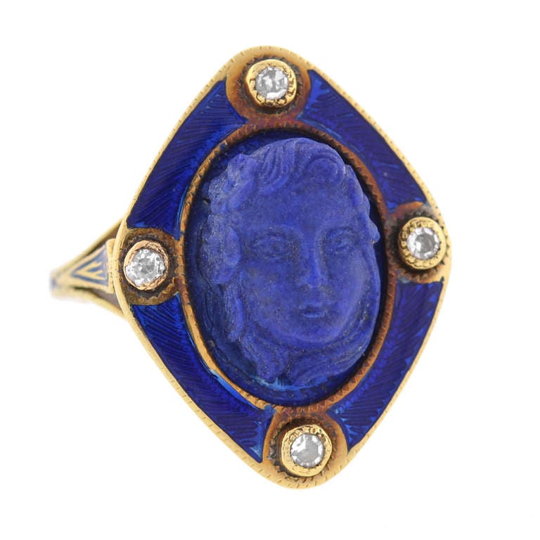 An exquisite carved lapis ring from the Victorian (ca1880) era! Made of 14kt yellow gold, the piece has a beautiful lapis set in the center of a complentary blue enameled frame. The lapis has a absolutely gorgeous hand carved cameo image of the face