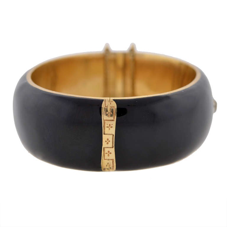 An absolutely fabulous enamel bracelet from the Victorian (circa 1880s) era! The bold bracelet, which is made of 14kt yellow gold, is particularly wide, with a hinged bangle design. The entire outer surface of the piece is covered in rich black