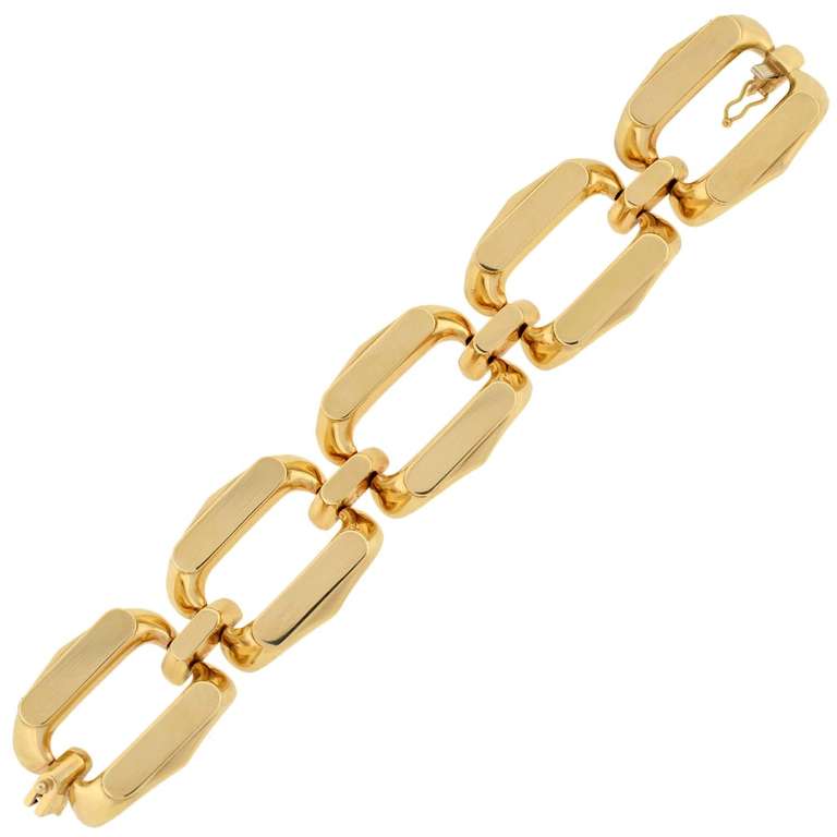 An absolutely fabulous gold Vintage bracelet from the 1960's! This stylish piece is made of smooth 14kt yellow gold and is comprised of 5 large open links. The links are oval in shape with flat, rectangular tops and cutout centers. Connecting each