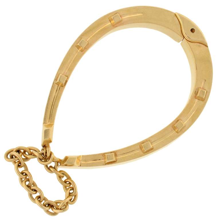 A fabulous horseshoe bracelet from the Victorian (ca1880) era! This gorgeous piece is made of 15kt yellow gold (indicating English origin) and forms the shape of a large horseshoe. The front side of the bracelet is detailed with 7 raised gold nails