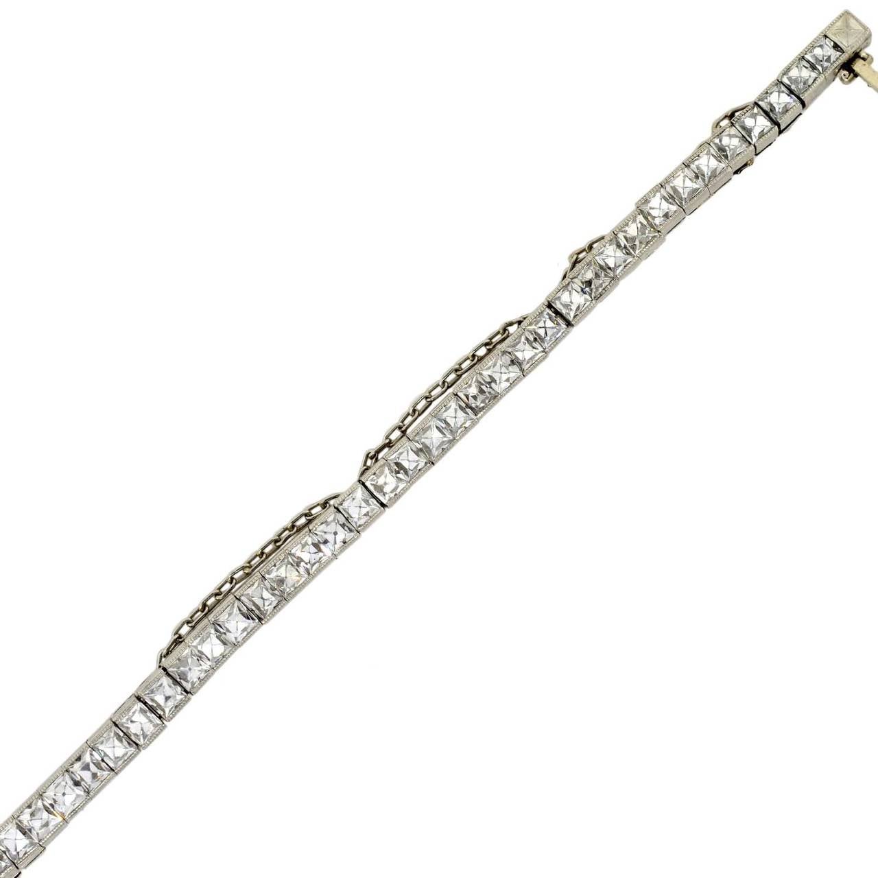 An absolutely stunning and unusual diamond line bracelet from the Art Deco (ca1920) era! Made of platinum, this gorgeous piece is comprised of 78 French Cut diamond links, which wrap around the entire length of the piece. Each faceted diamond stone