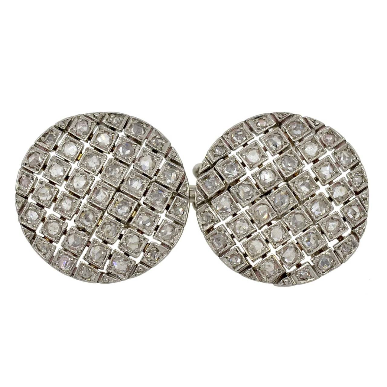 An exquisite pair of diamond cufflinks from the Edwardian (ca1910) era! Each double-sided cufflink is made of platinum and has a circular checkerboard design. A series of cutout lines forms the grid, with a single Rose Cut diamond set within each