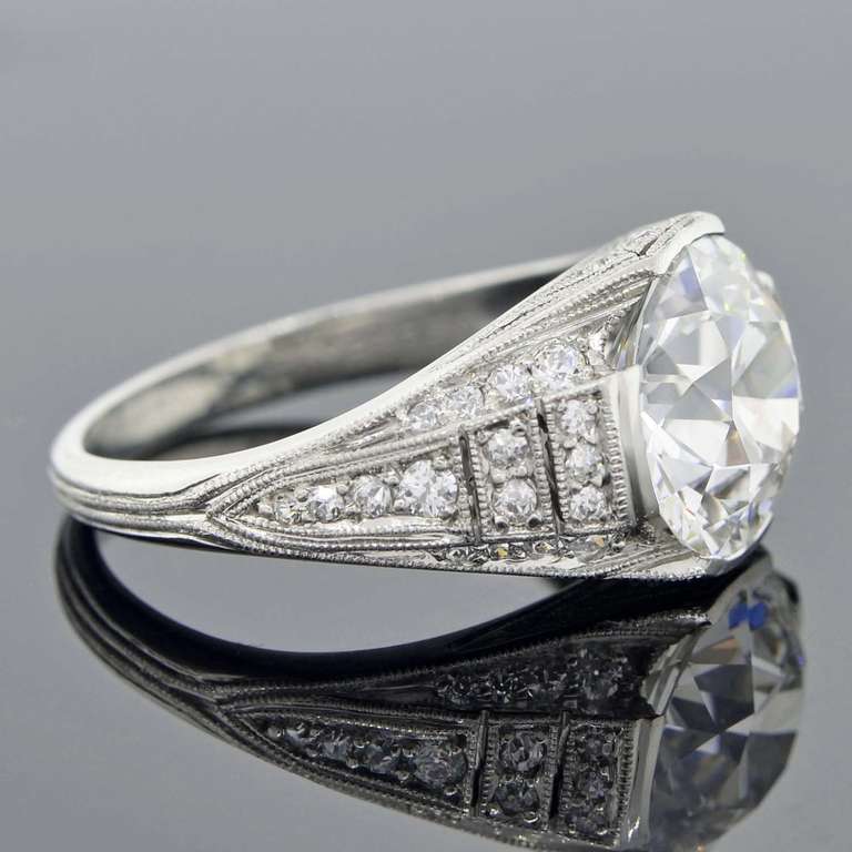 An incredible Art Deco (circa 1920) era diamond engagement ring from J.E. Caldwell & Co.! This beautiful piece has an old European Cut diamond at the center of a stunning ornate platinum mounting. The diamond has a partial bezel setting and a