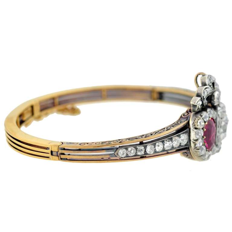 An absolutely exquisite diamond and ruby bracelet/pendant from the early Victorian (circa 1850) era! This breathtaking piece is made of 14kt rose gold and has an incredible design which can be worn as a bangle bracelet or a pendant. With a very
