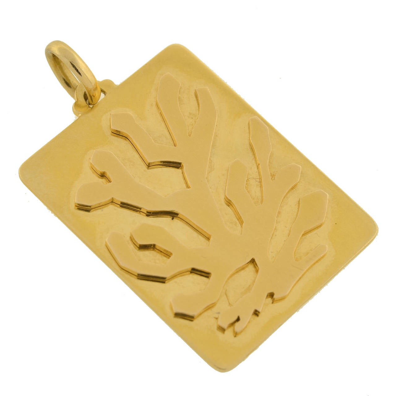 This fabulous vintage pendant is a signed piece by Bvlgari from the 1970's! Made of vibrant 18kt yellow gold, the pendant is very heavy and rather substantial in size. A raised, branch-shaped design decorates the top of a large rectangular gold