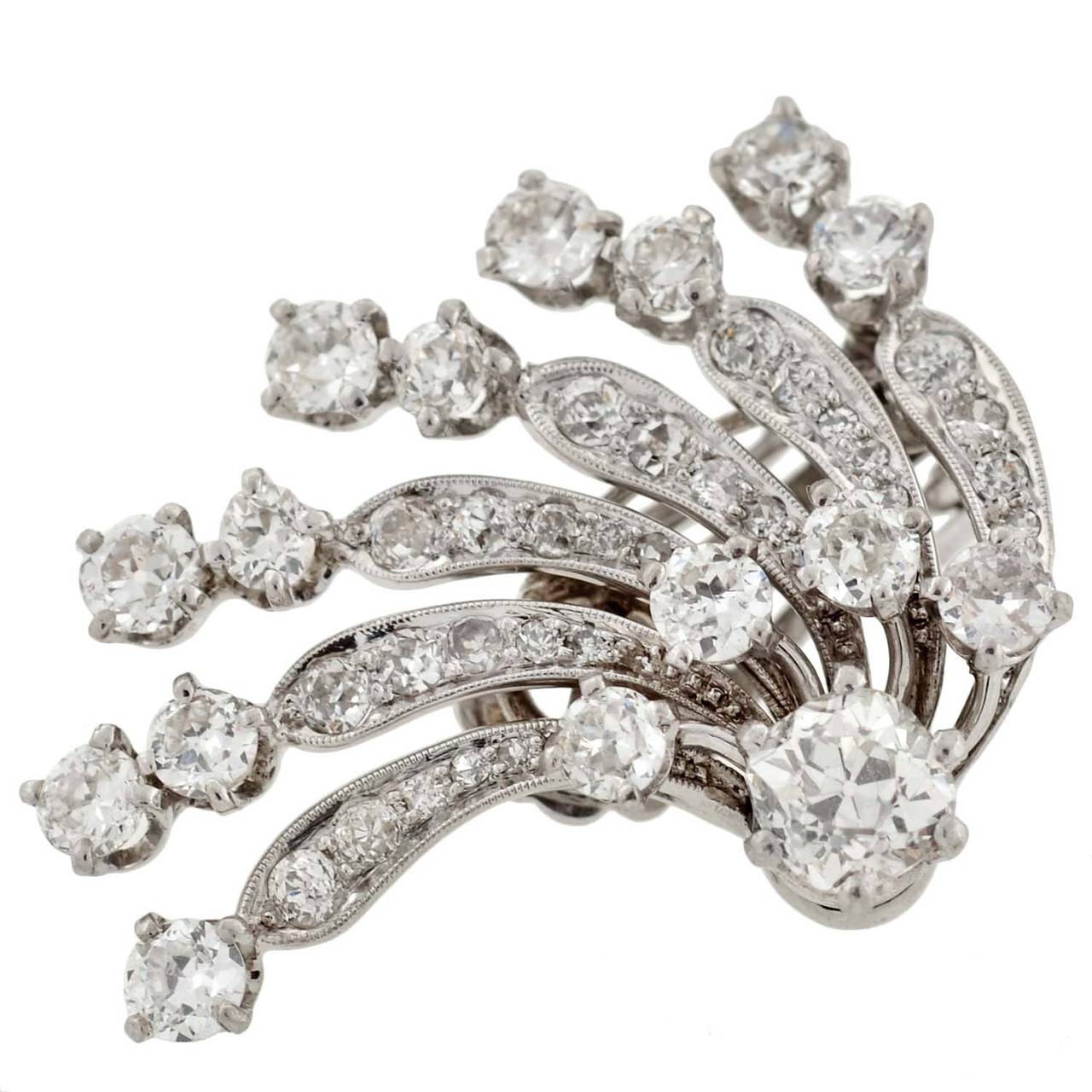 A dramatic pair of diamond earrings from the Early Retro (ca1935) era! These dazzling earrings are made of 14kt white gold and have a very eye-catching Retro look. Each earring features 6 curved 