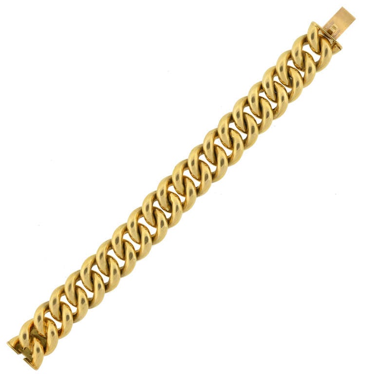 An absolutely fabulous gold link bracelet from the 1960s! This fashionable piece is comprised of large 18kt yellow gold rings that intertwine to form a flexible chain. The bracelet opens and closes at a push clasp, which is incorporated seamlessly