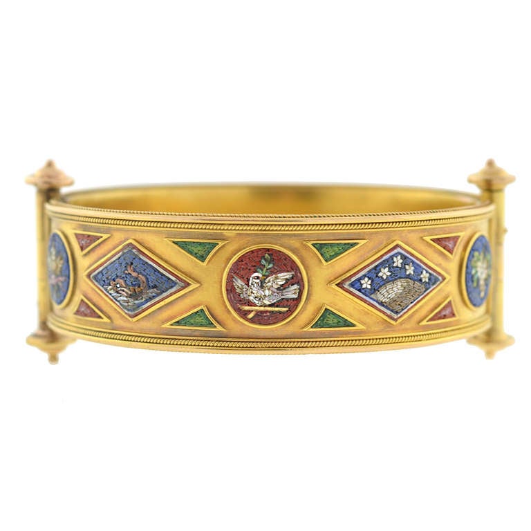 An exceptional micro mosaic bracelet from the Mid-Victorian (circa 1860) era! Made of vibrant 18kt yellow gold, this bangle style bracelet displays an incredible micro mosaic design on the front that carries all the way around the outer surface. The