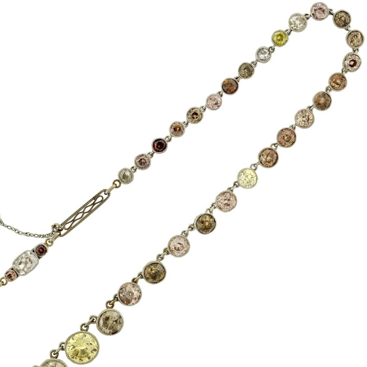 An exquisite and very unusual Edwardian multi-colored Riviera diamond necklace! Made of platinum, this stunning piece has 55 graduating old European Cut diamond stones which are set within a milgrained bezel setting. The stones are absolutely