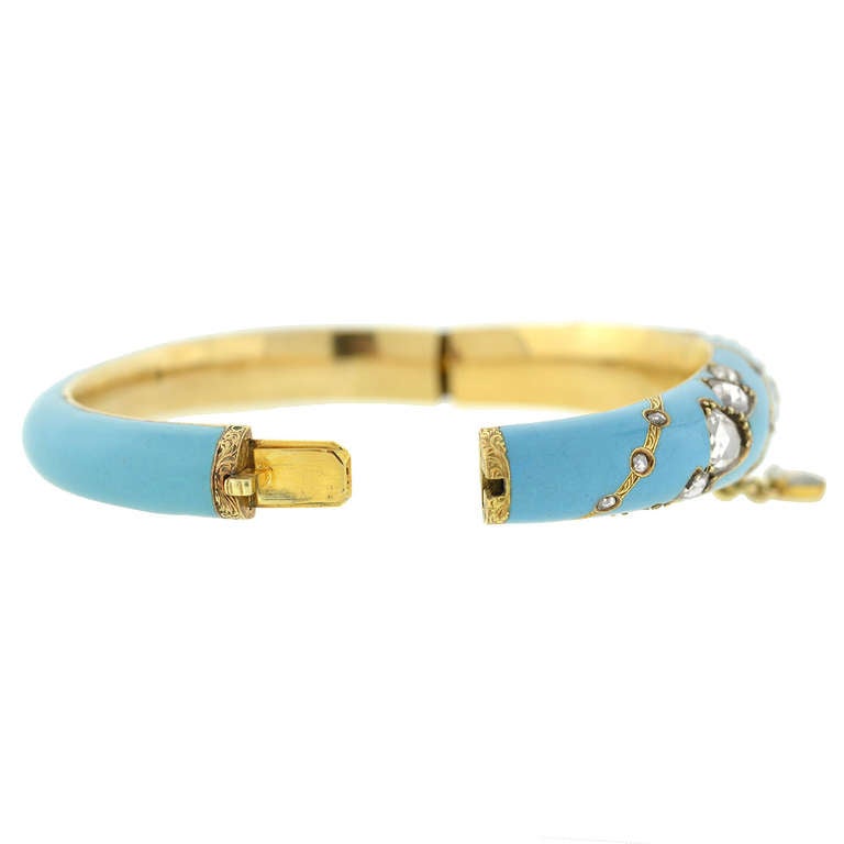 A beautiful and unusual bangle bracelet from the Victorian (ca1880) period! Made of 15kt yellow gold (indicating English origin), this fabulous piece has a very eye-catching design. The bracelet has a bright turquoise blue enamel surface which