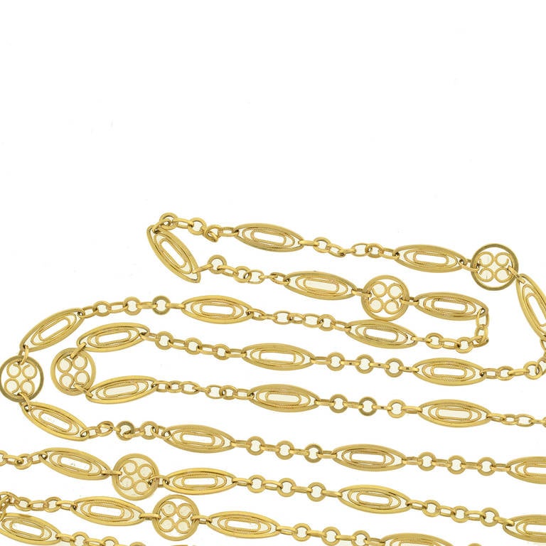 An absolutely gorgeous French chain from the Art Nouveau (ca1900) era! Extremely long in length, this fancy chain is comprised of vibrant 18kt yellow gold links, which have a beautiful filigree design. Featured throughout the chain are