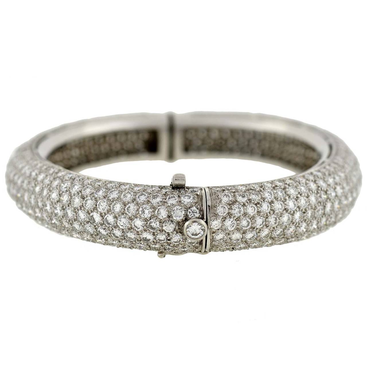 This Estate  micro pavé diamond bangle bracelet is quite a breathtaking piece! Made of platinum and hand wrought, the entire outer surface is completely encrusted with sparkling pavé diamonds, which glitter perfectly in the light. The diamonds are