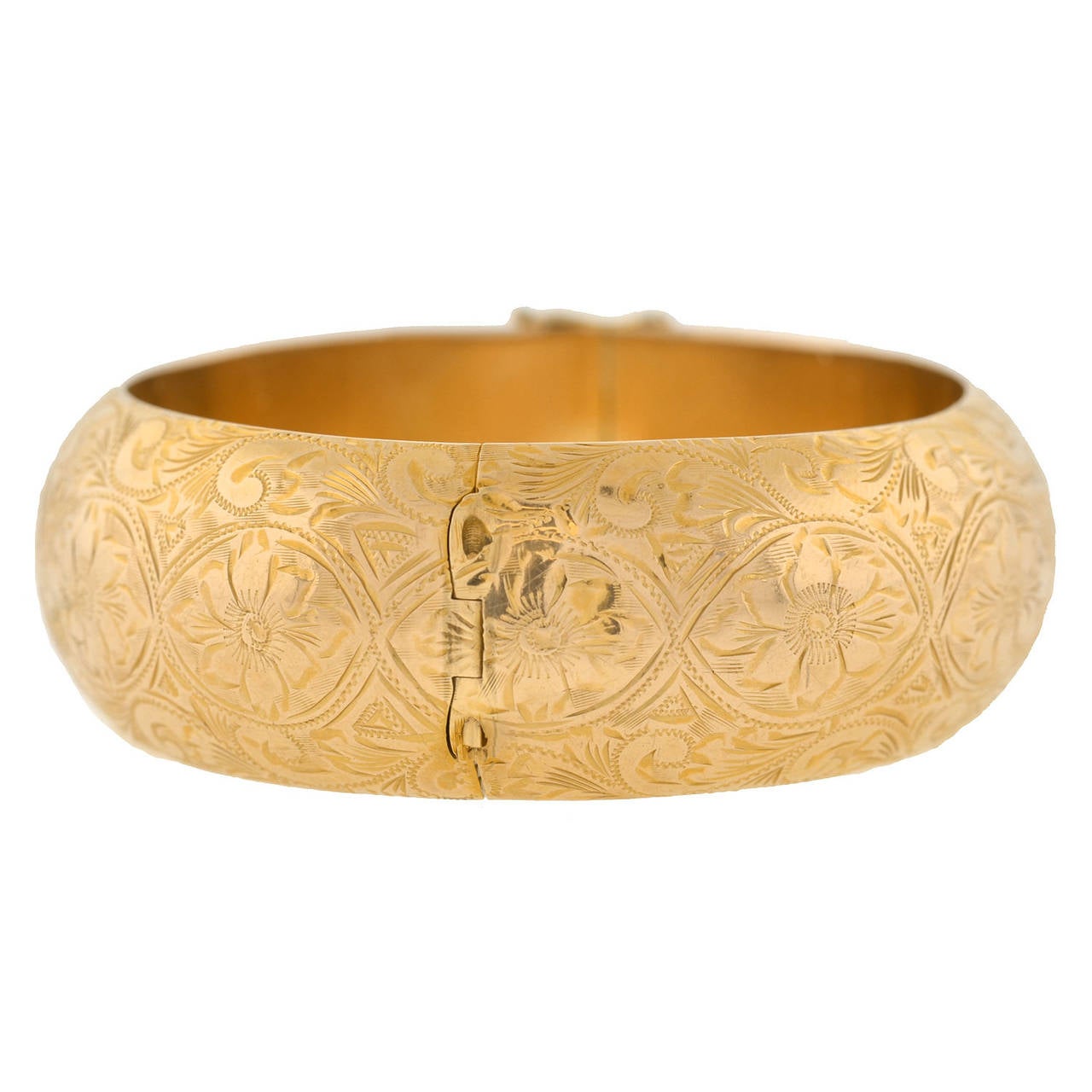 A fantastic Victorian Revival bracelet from the Retro (ca1940) era! This beautiful 14kt yellow gold piece is particularly wide and has a fine etched floral design which carries around the entire surface of the bracelet. The flowing feminine design