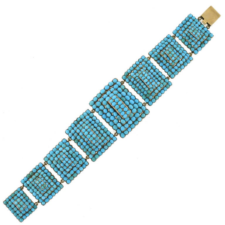 An outstanding turquoise bracelet from the Victorian (ca1880) era! This stunning piece is made of 9kt rosy yellow gold and is comprised of eight detailed pyramidal links. Each three-dimensional link is pavé set (French for 