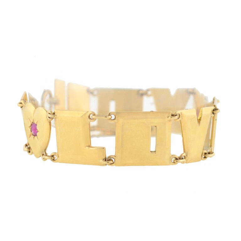 A charming gold link bracelet from the Retro (ca1940) era! This fabulous piece is made of 14kt yellow gold and has a very striking look. The piece is comprised of 10 links which spell out the words 