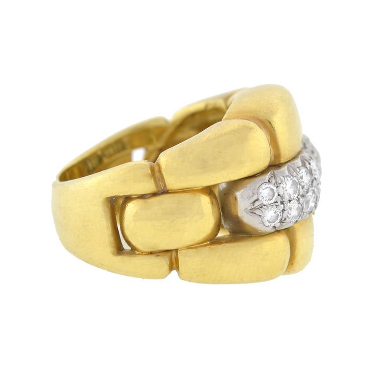 This fabulous Estate ring has a bold, fashionable look! Made of vibrant 18kt yellow gold, the piece is very substantial in size and has a striking contemporary design. The face of the ring is very wide and comprised of chunky 