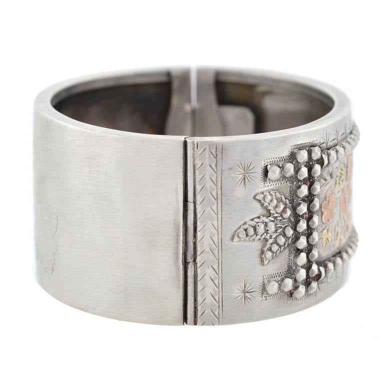 This rare sterling and mixed metals bracelet is a signed Tiffany & Co. piece from the Victorian (ca1880) era! Made of sterling silver, this beautiful piece is particularly wide and features a fine mixed metals floral design across the front surface.