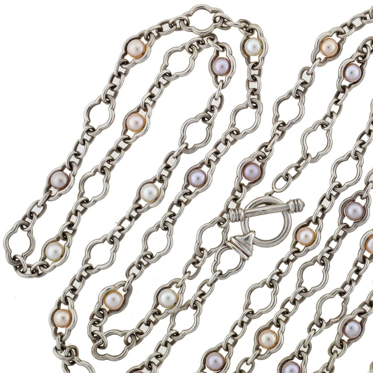 A fabulous pearl necklace from Charles Krypell! This stylish piece is extremely long in length and comprised of multicolored fresh water cultured pearls which are set within a heavy sterling chain. The chain has simple oval rings which alternate