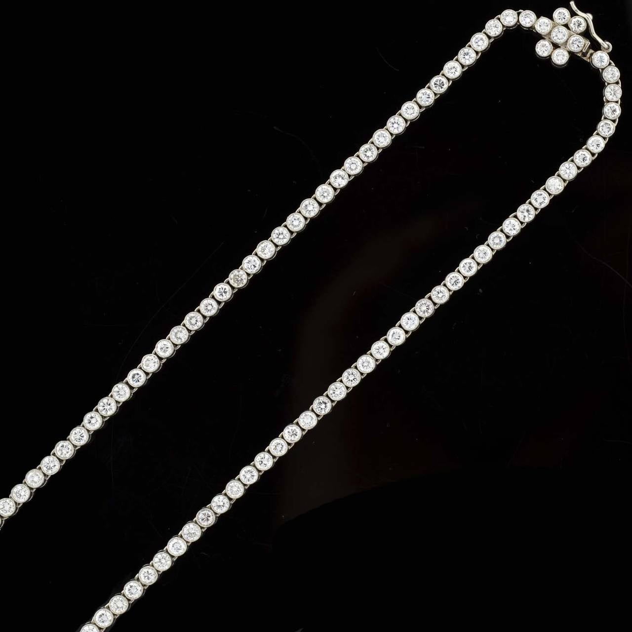 An exquisite Riviera diamond necklace! Made of platinum, this beautiful necklace has 122 graduating Brilliant Cut diamond stones which are set within a milgrained bezel setting. The diamonds are hinged together, allowing for beautiful movement when