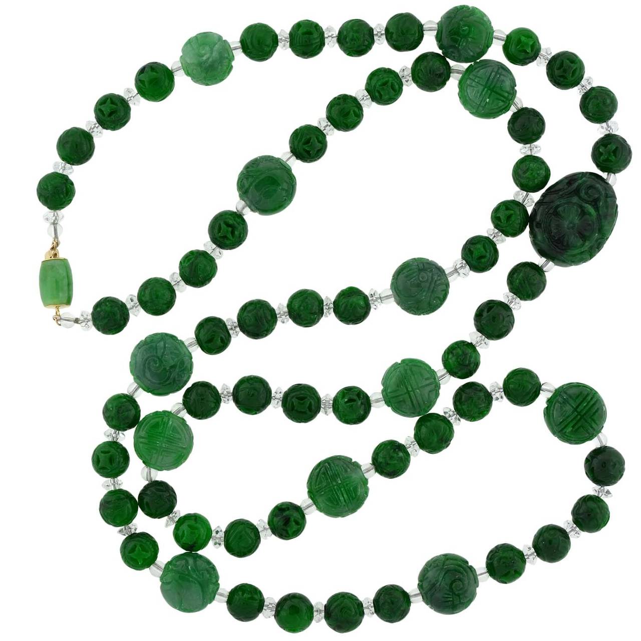 An incredible jade necklace from the Art Deco (ca1920) era! This beautiful piece is comprised of a single strand of hand carved jade beads which alternate with rock quartz crystal spacers. The necklace has a striking pattern of 4 round beads which
