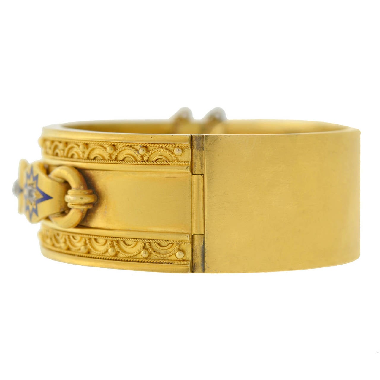 An absolutely outstanding bangle bracelet from the Victorian (ca1880) era! This wide bangle is made of vibrant 18kt yellow gold and has an exceptional three-dimensional design on the front surface. The top and bottom edges have an intricate Etruscan