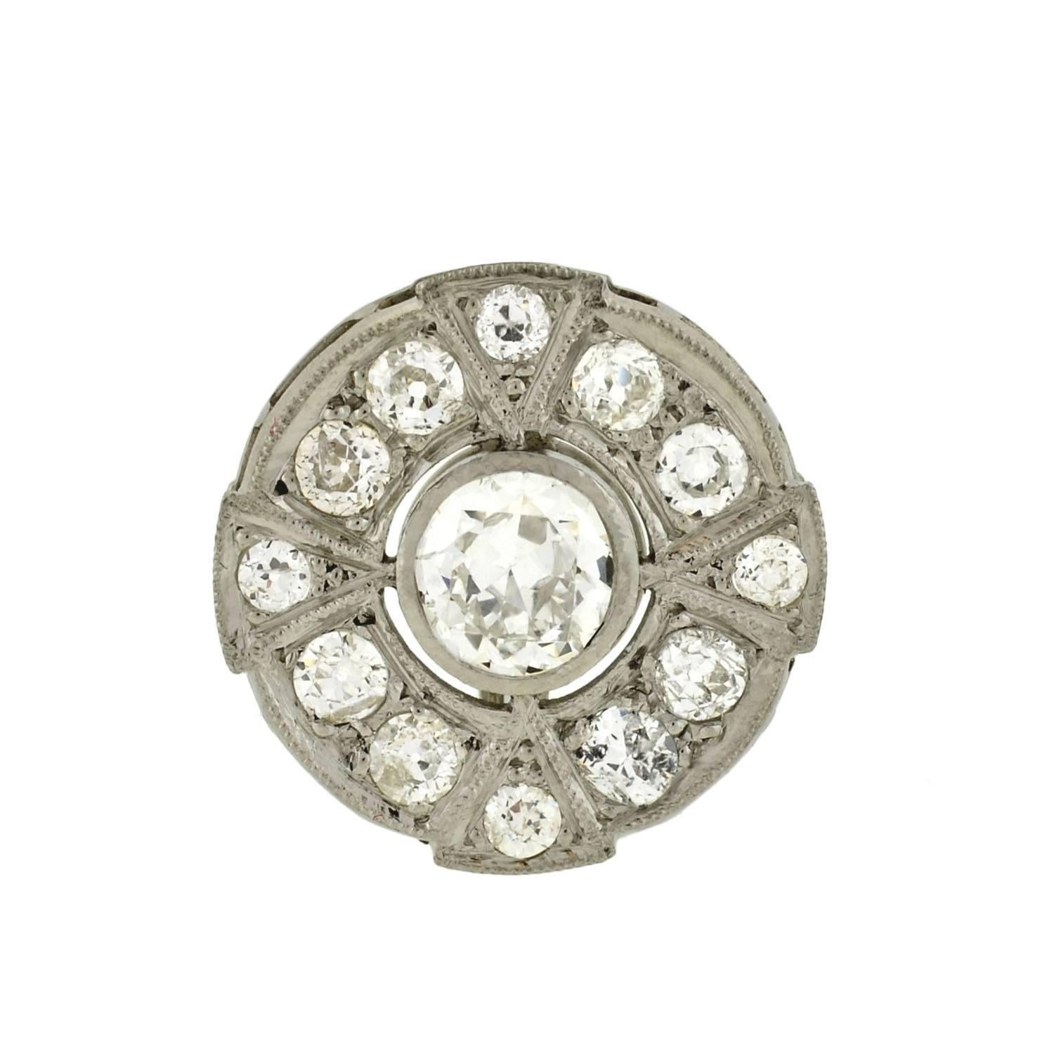 A gorgeous pair of diamond cluster earrings from the Art Deco (ca1920) era! These breathtaking studs are made of platinum and have a spectacular diamond encrusted design. Each round earring is comprised of a circular diamond border surrounding a