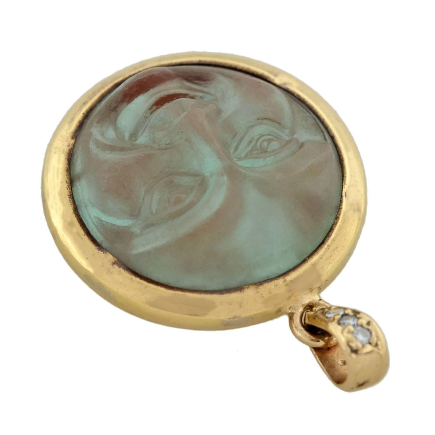 A wonderful "Man in the Moon" pendant from the Victorian (ca1880) era! This whimsical piece is crafted in 14kt yellow gold and features an alluring carved art glass center. The design portrays a recognizable "Man in the Moon"