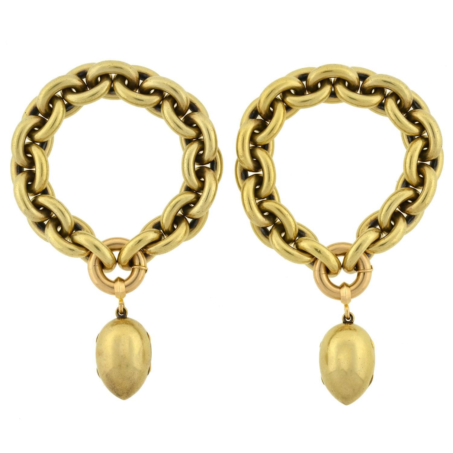 This magnificent Victorian era (ca1880) architectural piece has a convertible design that can be worn in several stylish ways! Made of 18kt yellow gold, the piece is comprised of a heavy link chain and two removable egg-shaped locket fobs. The chain