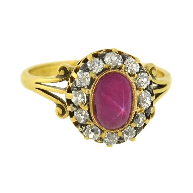 A breathtaking star sapphire ring from the Late Victorian (ca1900) era! Made of vibrant 18kt gold, this lovely piece holds a beautiful pink star sapphire cabochon in the center. When turned in the light, the stone's iridescent flashes reveal a