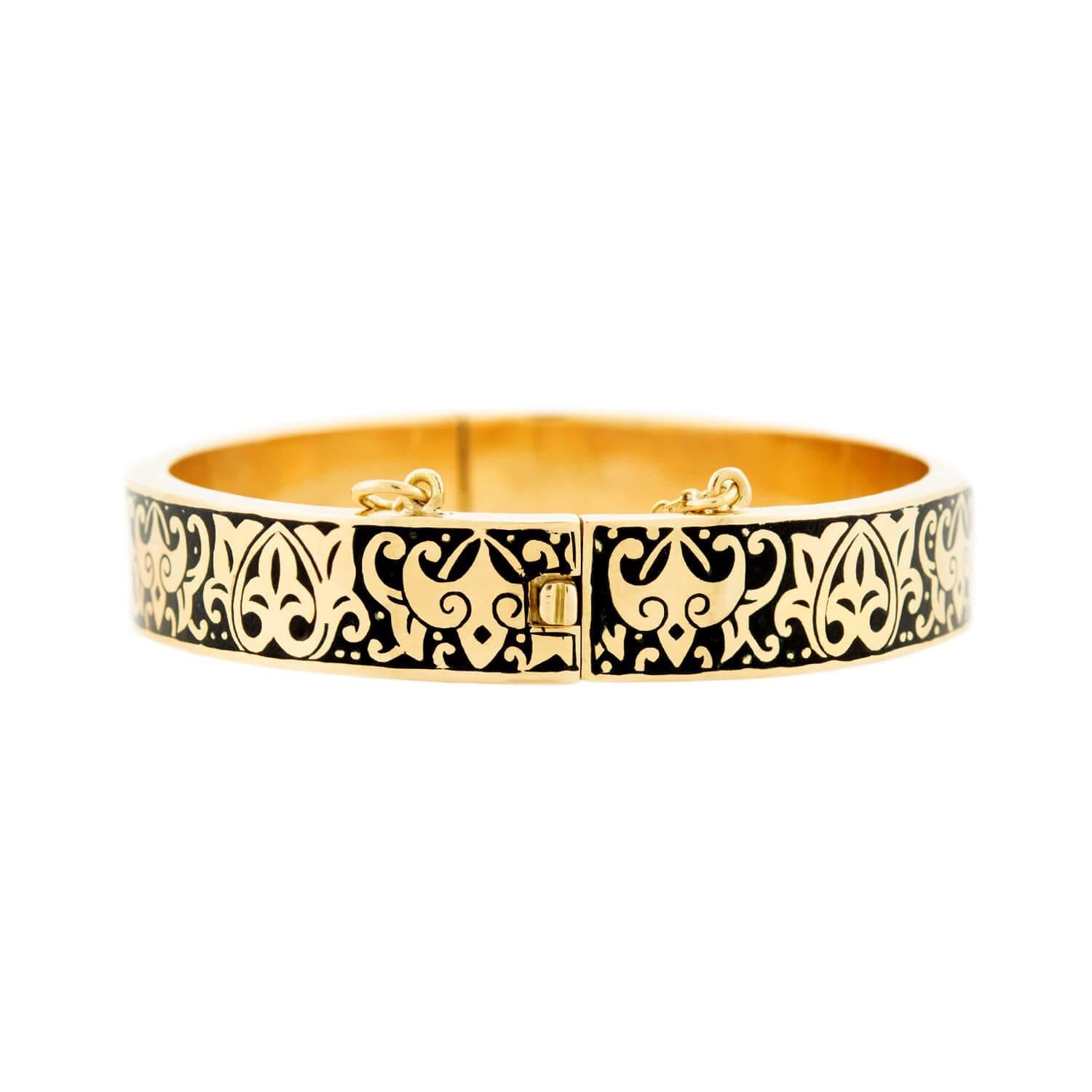 An absolutely stunning enameled bracelet from the Victorian (ca1880) era! Crafted in 14k yellow gold, this gorgeous bangle features intricate black tracery enamel work. The entire surface of the bracelet is adorned with scrolling motifs, which add