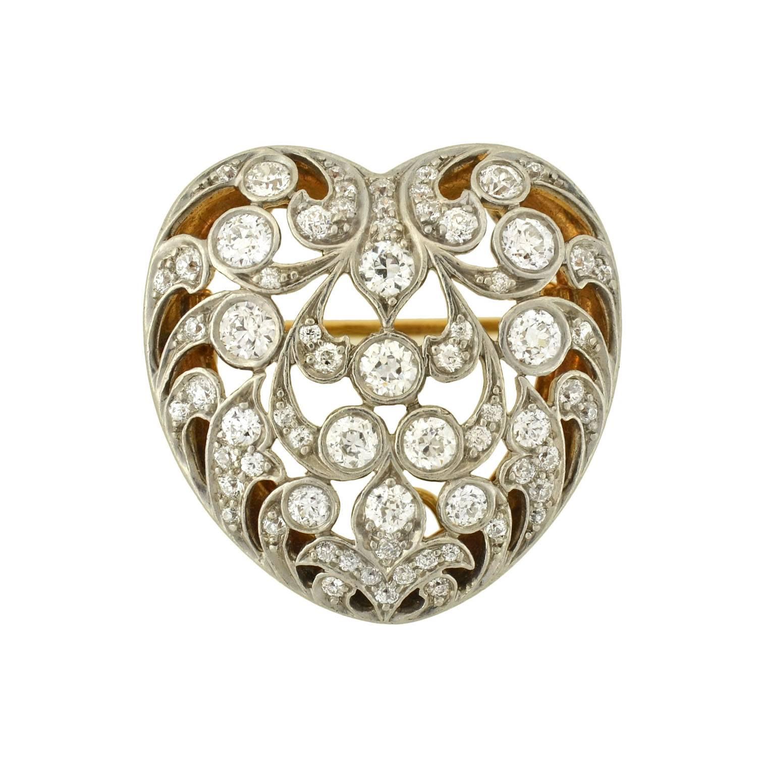 A gorgeous Tiffany & Company diamond heart pin/pendant from the Edwardian era (ca1910). This convex shaped puffy heart has a lacy floral motif which was common for the Edwardian period. The pin/pendant is comprised of approximately 2.5ctw of