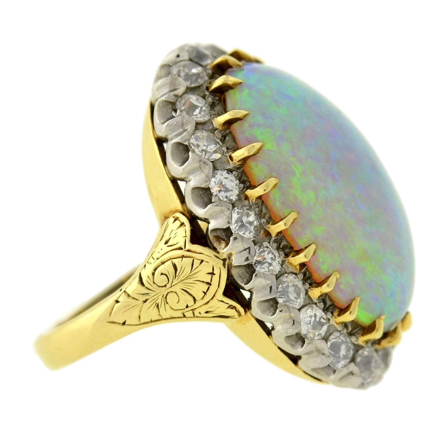 A simply exquisite and unusual opal and diamond ring from the Victorian era! This fabulous ring has a single oval-shaped cabochon opal stone set in its center. The stone, which is particularly large in size, is prong set in yellow gold and has