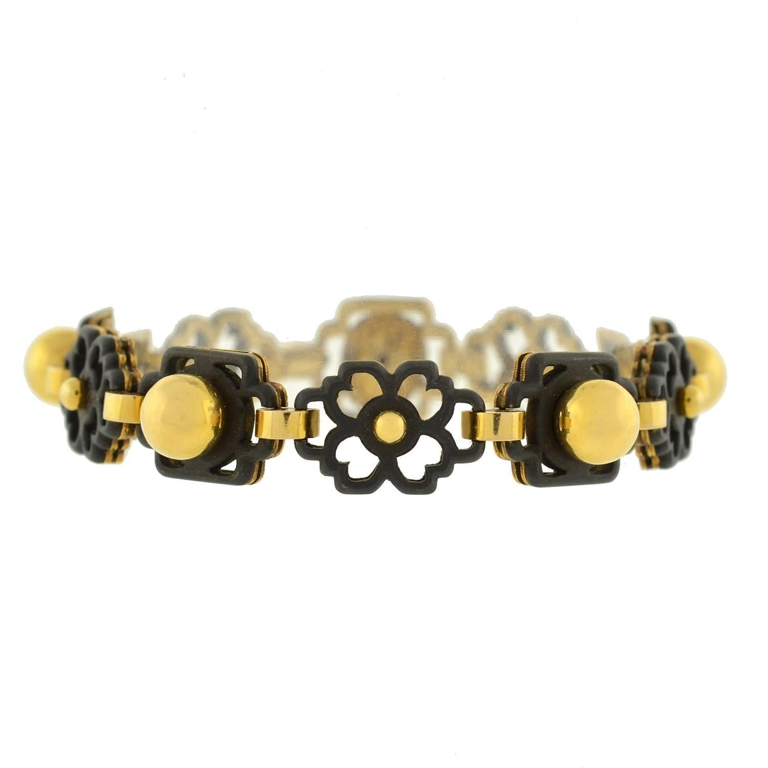 A fabulous vintage Marsh & Company gold and steel link bracelet from the 1950's! This gorgeous bracelet is made of 18kt yellow gold, and comprised of 5 flower-shaped links that alternate with 5 square links. All 10 links are topped in oxidized steel
