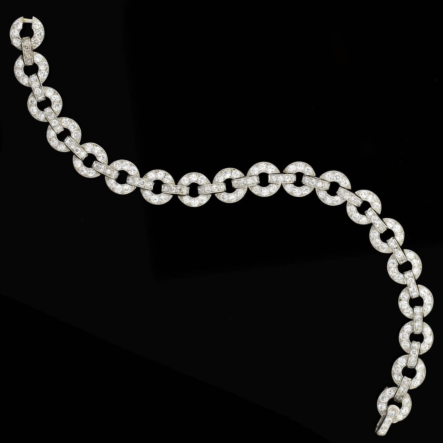 A gorgeous diamond encrusted bracelet from the Art Deco (ca1920) era! This breathtaking piece is made of platinum and features 19 circular links that are hinged together, forming a straight but flexible line bracelet. All of the open links and
