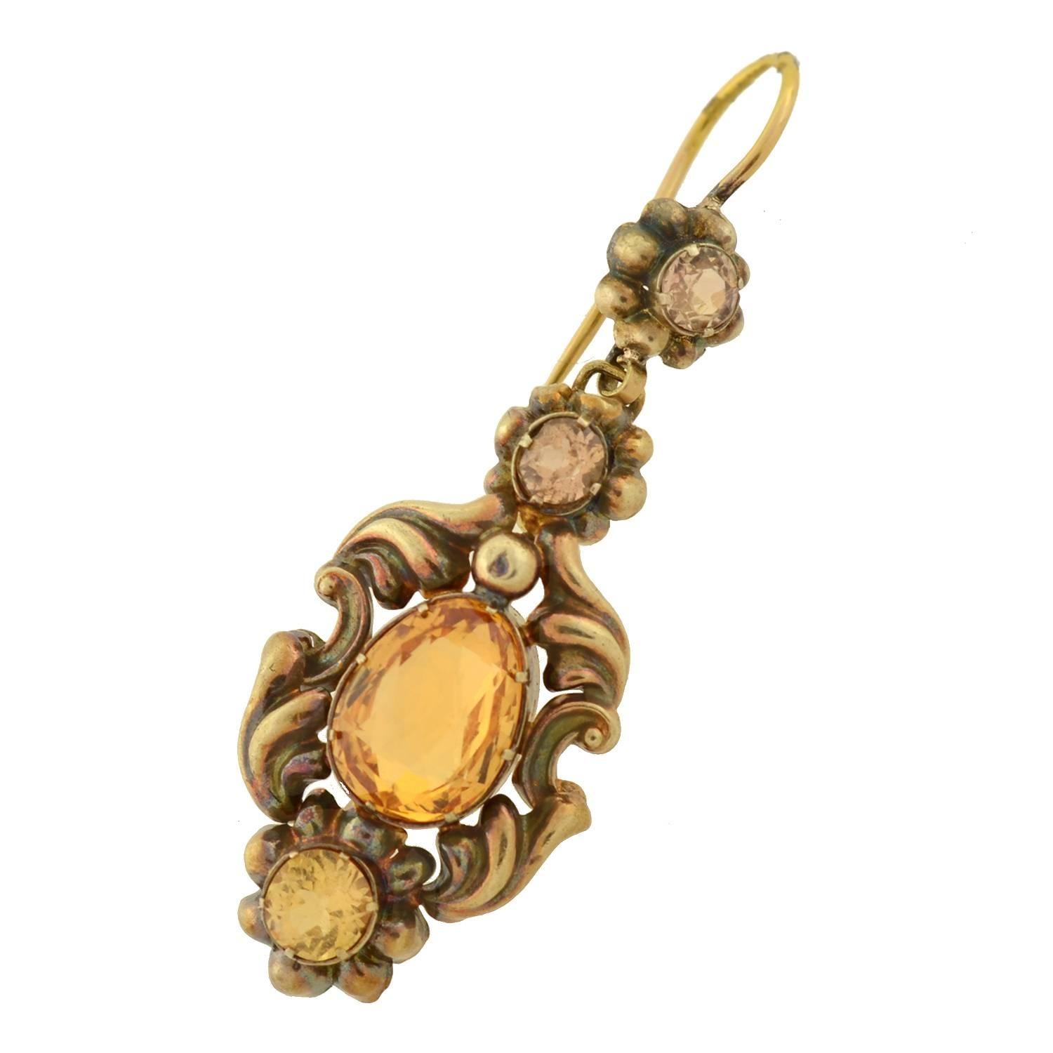 Absolutely stunning citrine earrings from the Victorian (ca1880) era! These wonderful earrings are made of 14kt yellow gold and detailed with citrines and yellow zircons. Fairly long in length, each earring begins with a faceted smoky colored yellow