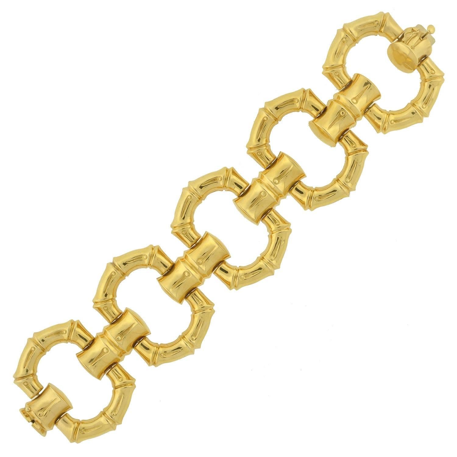 This gold contemporary bracelet makes a very big statement! This stylish piece is made of oversized 18kt yellow gold links and has a very substantial look and feel. Each open link has a smooth surface on one side and a brushed bamboo link gold