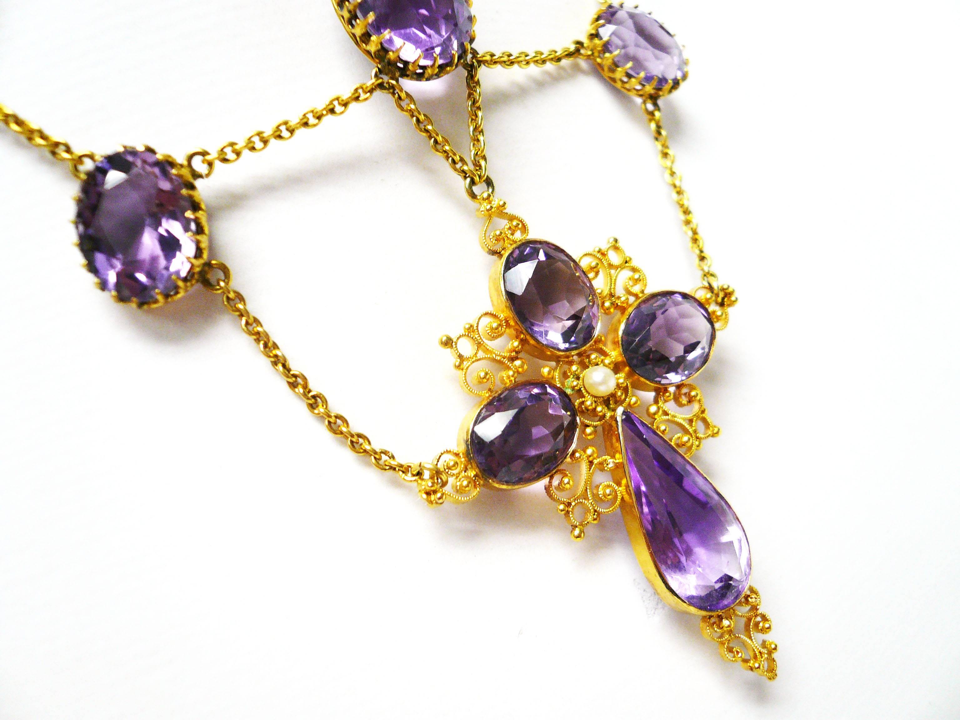 Beautiful Amethyst 14 Karat Gold Ecclesiastic Cross Swag Necklace

Amethysts were fashionable gemstones throughout the Victorian era.  This charming swag necklace features 35 carats of amethyst gemstone set in 18 karat yellow gold.  Because of its