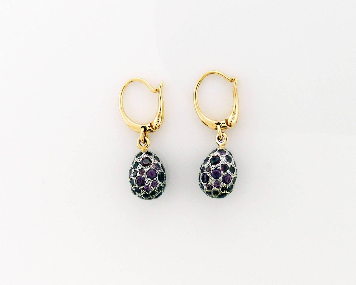 This authentic pair of earrings are by Pomellato, they are crafted from solid 18k in white and yellow gold with a paved finish featuring hook backs with a dangling fruit like shape amethyst. It is signed by the designer with the metal