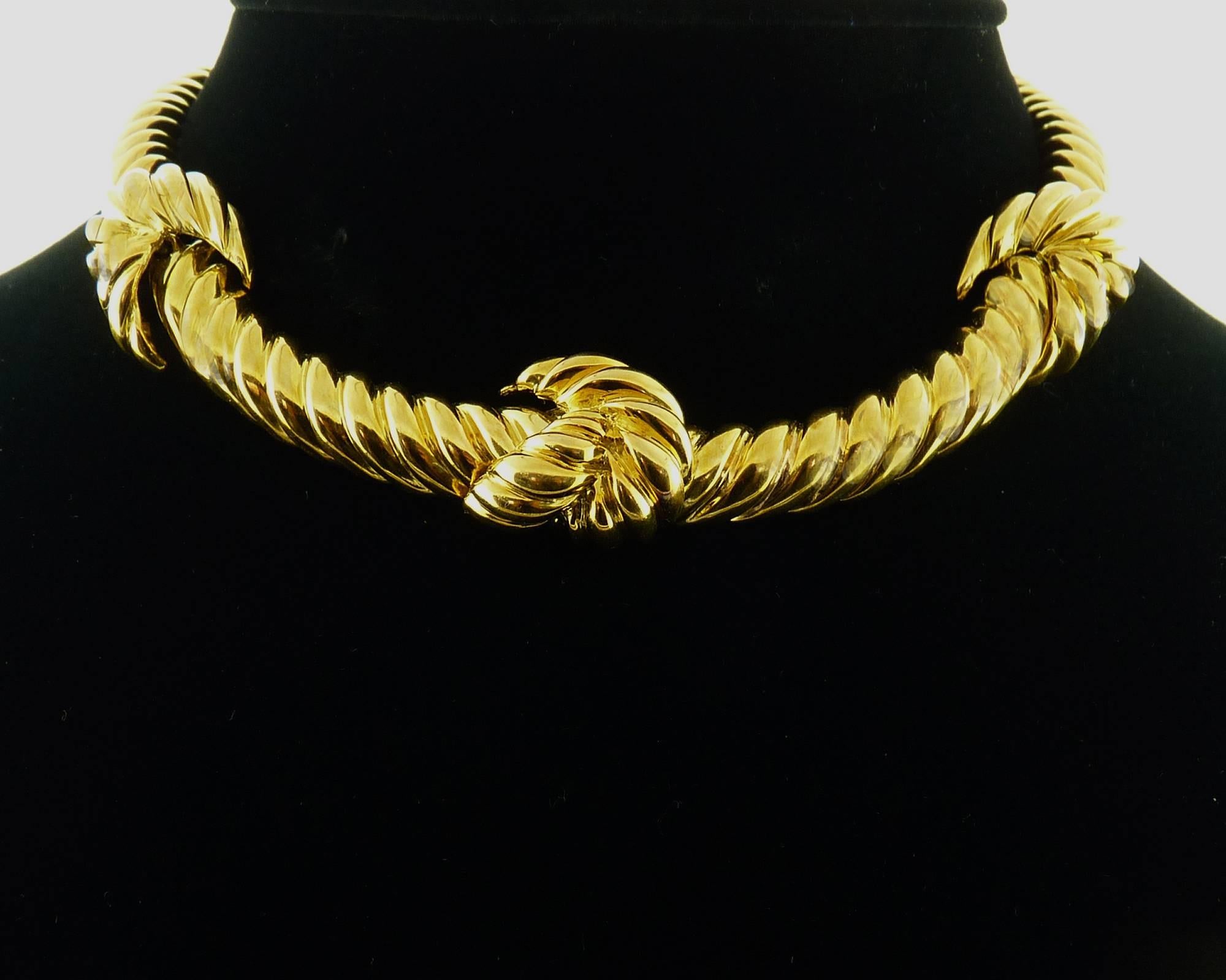 Timeless 18 Karat Yellow Gold twisted choker necklace by renowned designer David Webb.
The necklace is embellished by four knots, the fourth is hiding the clasp. 
There is a safety clasp which is signed WEBB 18K
The necklace is about 1/2 inch wide.