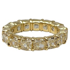 Light Yellow Cushion Diamond Eternity Ring 7.47 Carats in 18k Yellow Gold